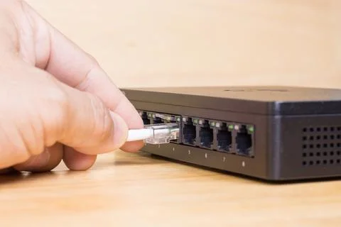 Hand of man holding The network cables to connect Lan port, concept Communi.. 库存照片
