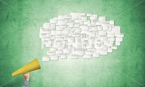 Hand of man holding red paper trumpet and speech cloud Stock Photos