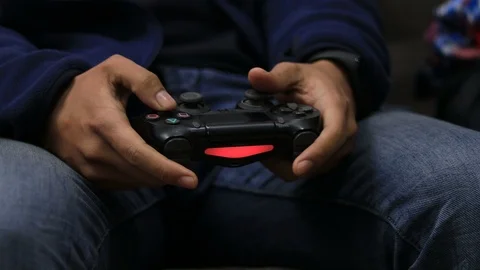 Hand of a man holding wireless game controller and playing console game Stock Footage 124524633