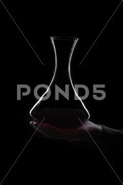 Hand of man holds decanter with red wine Stock Photos