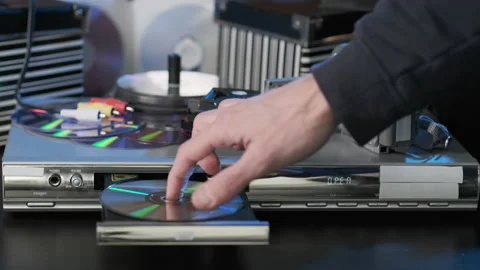 Hand of Man Inserting Disc into DVD Player Stock Footage 169863764