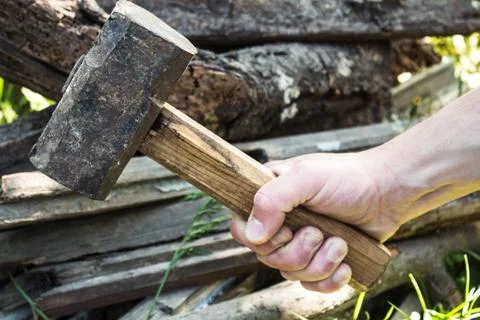 The hand of a man with a large hammer Stock Photos