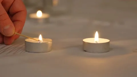 Hand of man lover taking fire from one candle to the other one. love as life is Stock Footage 145777591