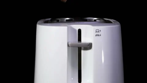 Hand of man  with modern white kitchen toaster in work . Slow motion Stock Footage 124944036