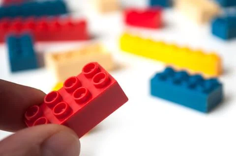Hand of man playing with plastic bricks construction Stock Photos