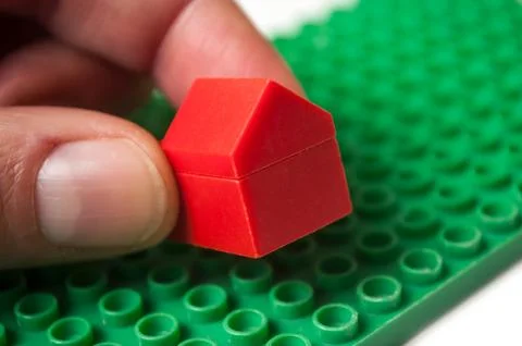 Hand of man playing with plastic bricks construction Stock Photos