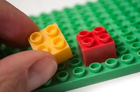 Hand of man playing with plastic bricks construction 스톡 사진