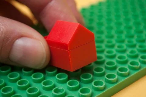Hand of man playing with plastic bricks construction Stock Photos