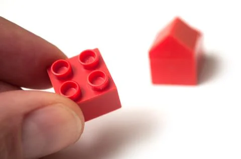Hand of man playing with plastic bricks construction Stock Photos