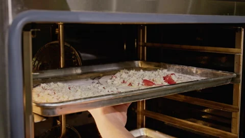 Hand of Man Putting Baking Sheet with Raw Pizza into Commercial Oven Stock Footage 339504015