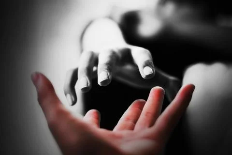 Hand of Man reaching to help the boy in the dark Stock Photos