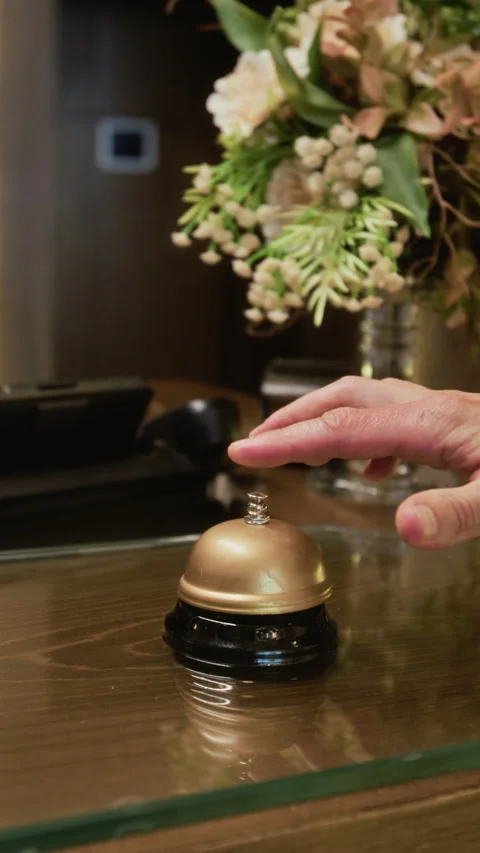 Hand of Man Ringing Service Bell at Hotel Reception Counter Stock Footage 345838319