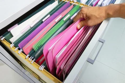 Hand of Man Search files document in a file cabinet in work office Photos