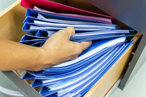 Hand of Man Search files document in a file cabinet in work office Photos