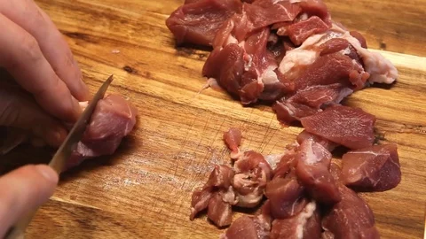 Hand of a man slices meat on a kitchen board Stock Footage 85163474