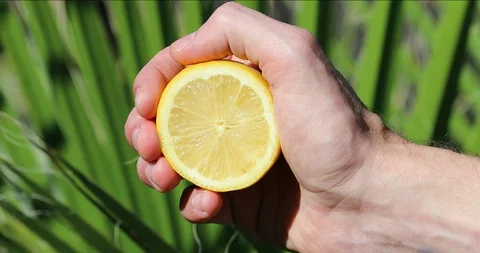 Hand Of Man Squeezing Lemon Stock-Footage 98149729