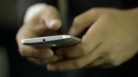 A hand of a man in a suit typing on his cell phone Stock Footage 275355440
