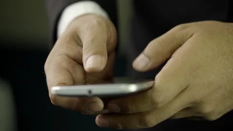 A hand of a man in a suit typing on his cell phone Stock Footage 275355452