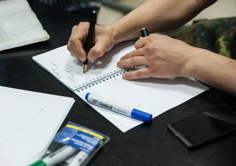 Hand man takes notes in a notebook Stock Photos