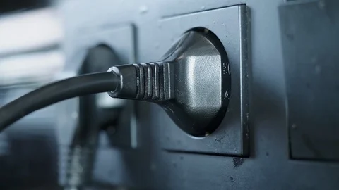 Hand of man takes out two black electrical plugs from black electrical outlets 스톡 동영상 126209634