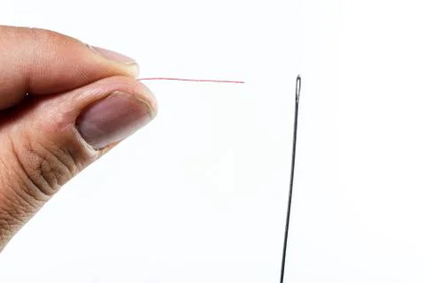 Hand of man threading a needle Stock Photos