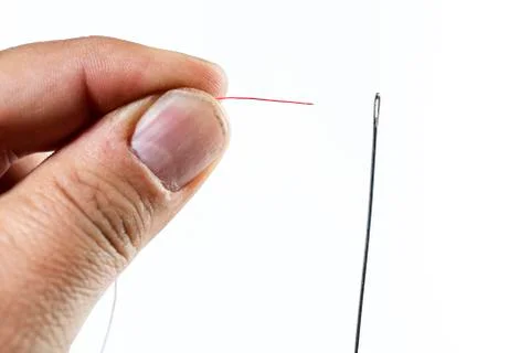 Hand of man threading a needle Stock-Fotos