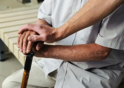 Hand of man touching hands elderly man Stock Photos
