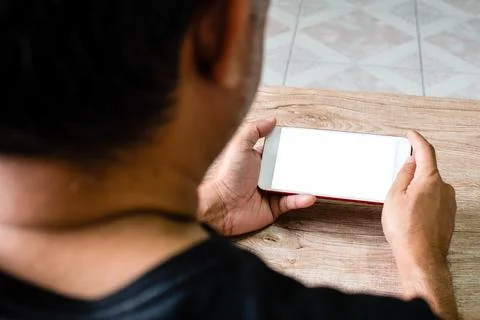 Hand of man touching horizontal mobile smartphone with a blank white screen.. Stock Photos