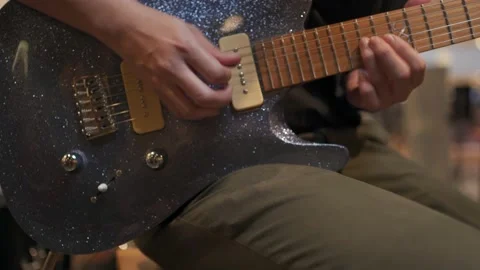 Hand of man touching strings of electric guitar during performing Stock Footage 205133137