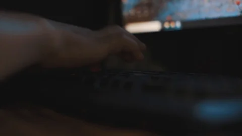 Hand of man typing on keyboard at midnight doing work. Selective focus. Stock Footage 93110016