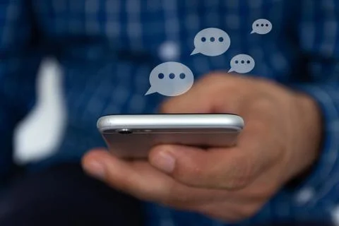 Hand of man typing text on mobile smartphone. Online  chat chatting on applic Stock Photos