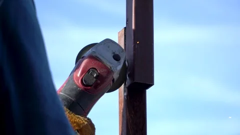 The hand of man using Electric grinder grind the metal pipe. Stock Footage 255919686