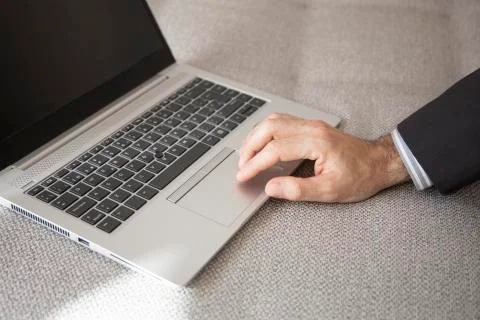 Hand of a man using laptop computer working at home Foto stock
