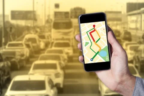 Hand of man using map on smartphone application with traffic jam background. Stock Photos