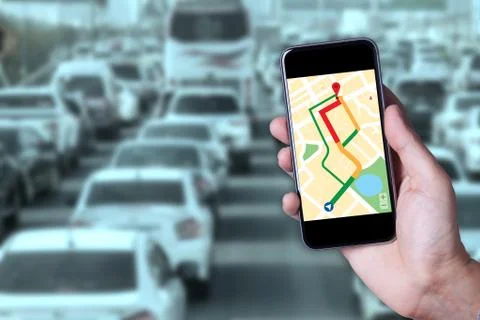 Hand of man using map on smartphone application with traffic jam background. Stock Photos