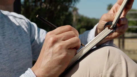 Hand Of A Man Using A Pencil On A Notebook Stock Footage 277119112