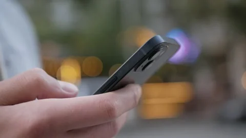 Hand of man using of smartfone at street, typing message. Stock Footage 218570336