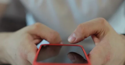 Hand of man using smartphone in the living room at home. Close-up of young man Stock Footage 269128141