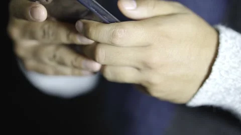 Hand of a man using social networks through his cell phone Stock Footage 272255382