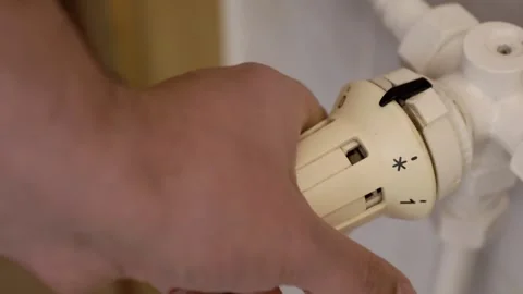 Hand of a man using a thermostat to adjust the temperature Stock Footage 326043842
