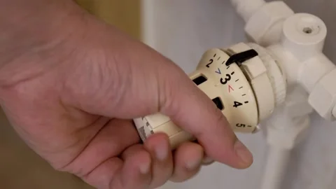 Hand of a man using a thermostat to adjust the temperature Stock Footage 326043849