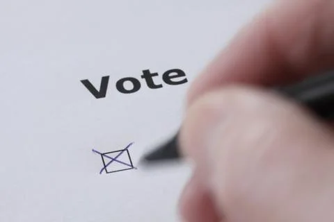 Hand of man voting - sets mark in check box with pen Stock Photos