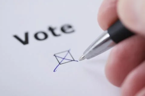 Hand of man voting - sets mark in check box with pen Stock Photos
