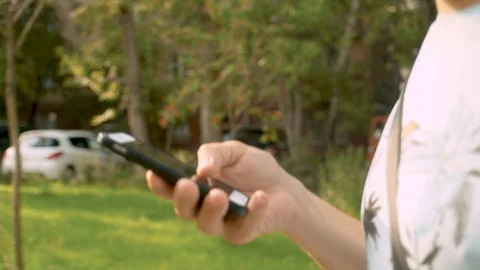 Hand of a man walking and scrolling the smart phone Video stock 114626245