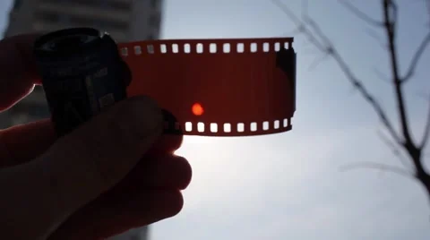Hand of man which looks partial solar eclipse through film Stock Footage 61771038