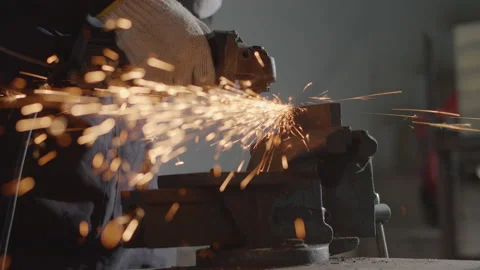 Hand of man work wearing gloves while Grinding metal and orange flying sparks Stock Footage 137014653