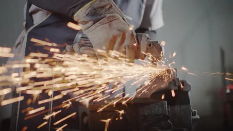 Hand of man work wearing gloves while Grinding metal and orange flying sparks Stock Footage 137030391