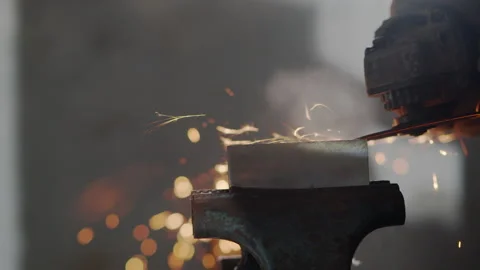Hand of man work wearing gloves while Grinding metal and orange flying sparks Stock Footage 137030442