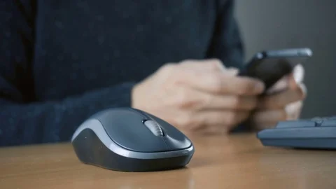 Hand of a man working at computer and using smartphone Stock Footage 83432436