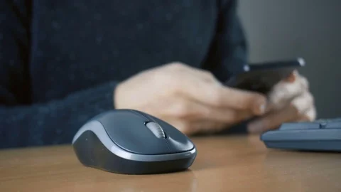 Hand of a man working at computer and using smartphone Stock Footage 84280502
